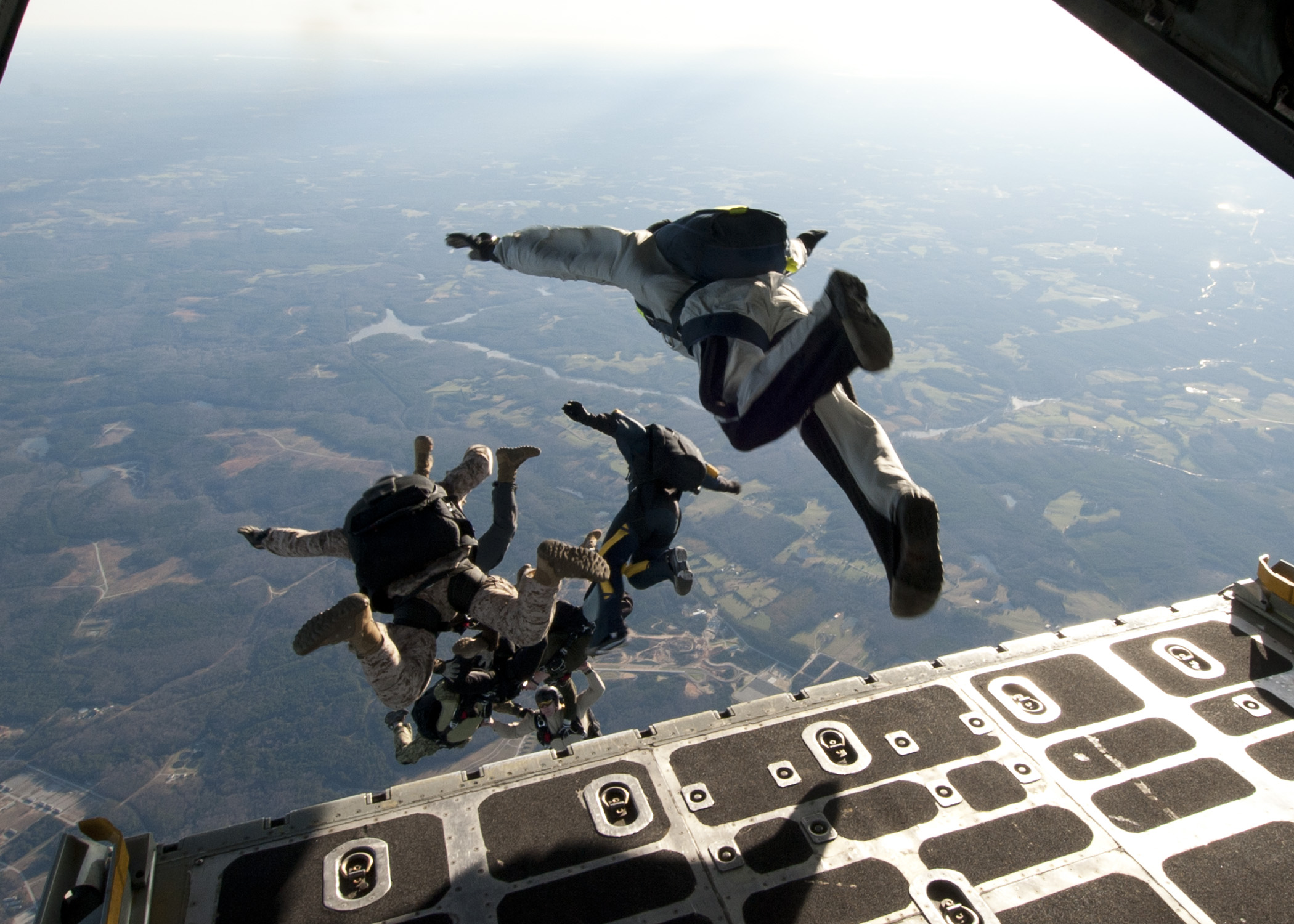 Navy Seals jumping from an aircraft
